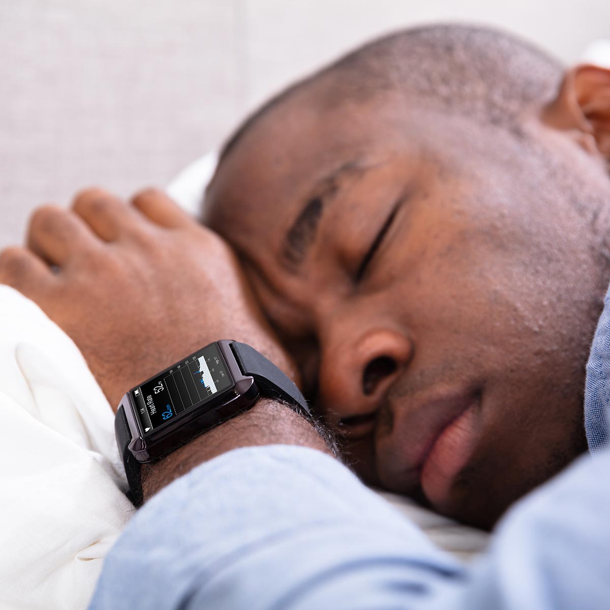 Man sleeping with smartwatch